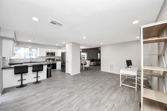 a view of kitchen with furniture and wooden floor