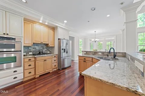 a kitchen with stainless steel appliances white cabinets and a refrigerator