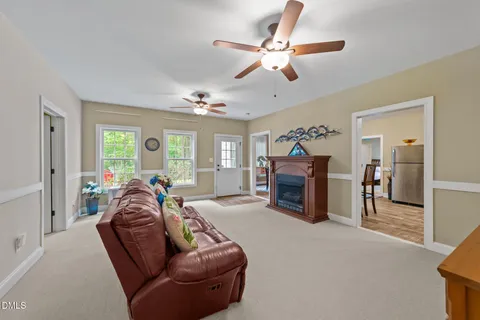 a open kitchen with stainless steel appliances granite countertop a refrigerator dining table and chairs