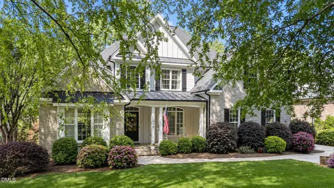 front view of a brick house with a yard