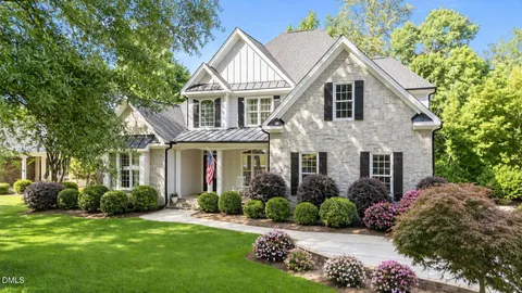 a front view of a house with a garden and plants