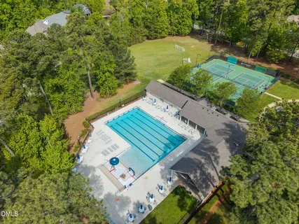a view of swimming pool with trees in the background