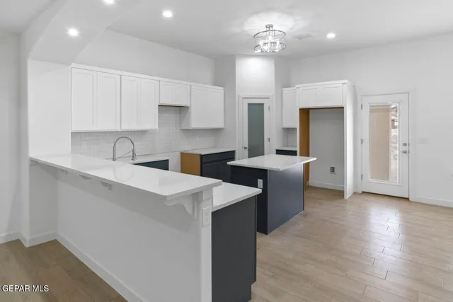 a view of kitchen with sink microwave and refrigerator