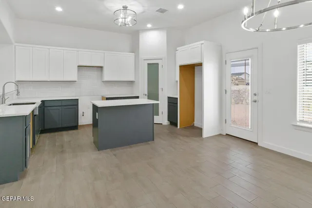 a view of a kitchen with a sink cabinets and stainless steel appliances