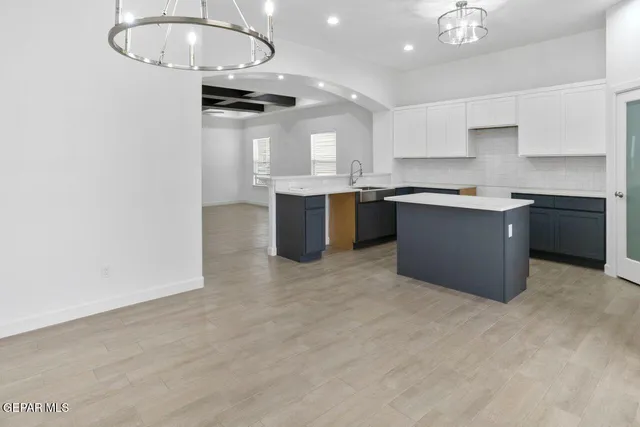 a kitchen with stainless steel appliances granite countertop a sink a stove and a refrigerator