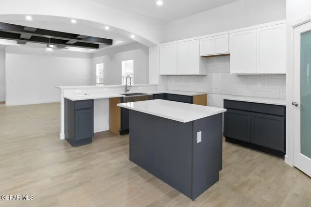 a kitchen with a sink stove and cabinets