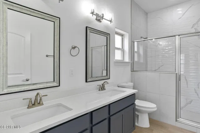 a bathroom with a granite countertop sink mirror and vanity