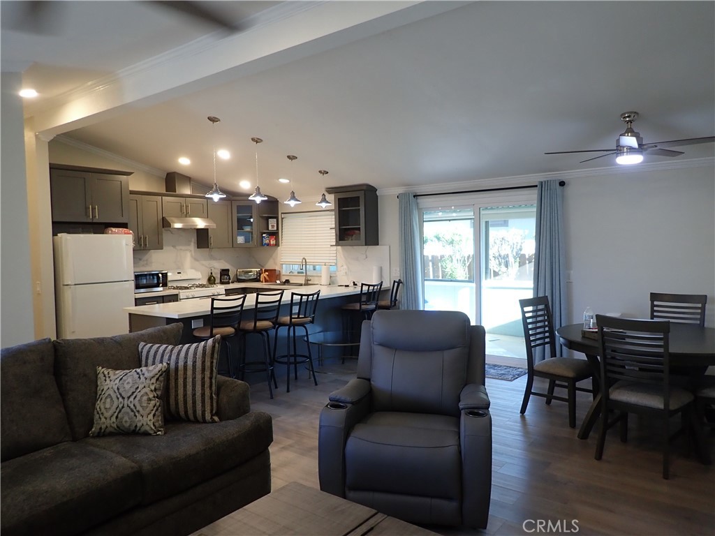 27250 Murrieta Road, Unit 386 Menifee, CA 92586 - Photo 7 of 32 a living room with furniture and kitchen view
