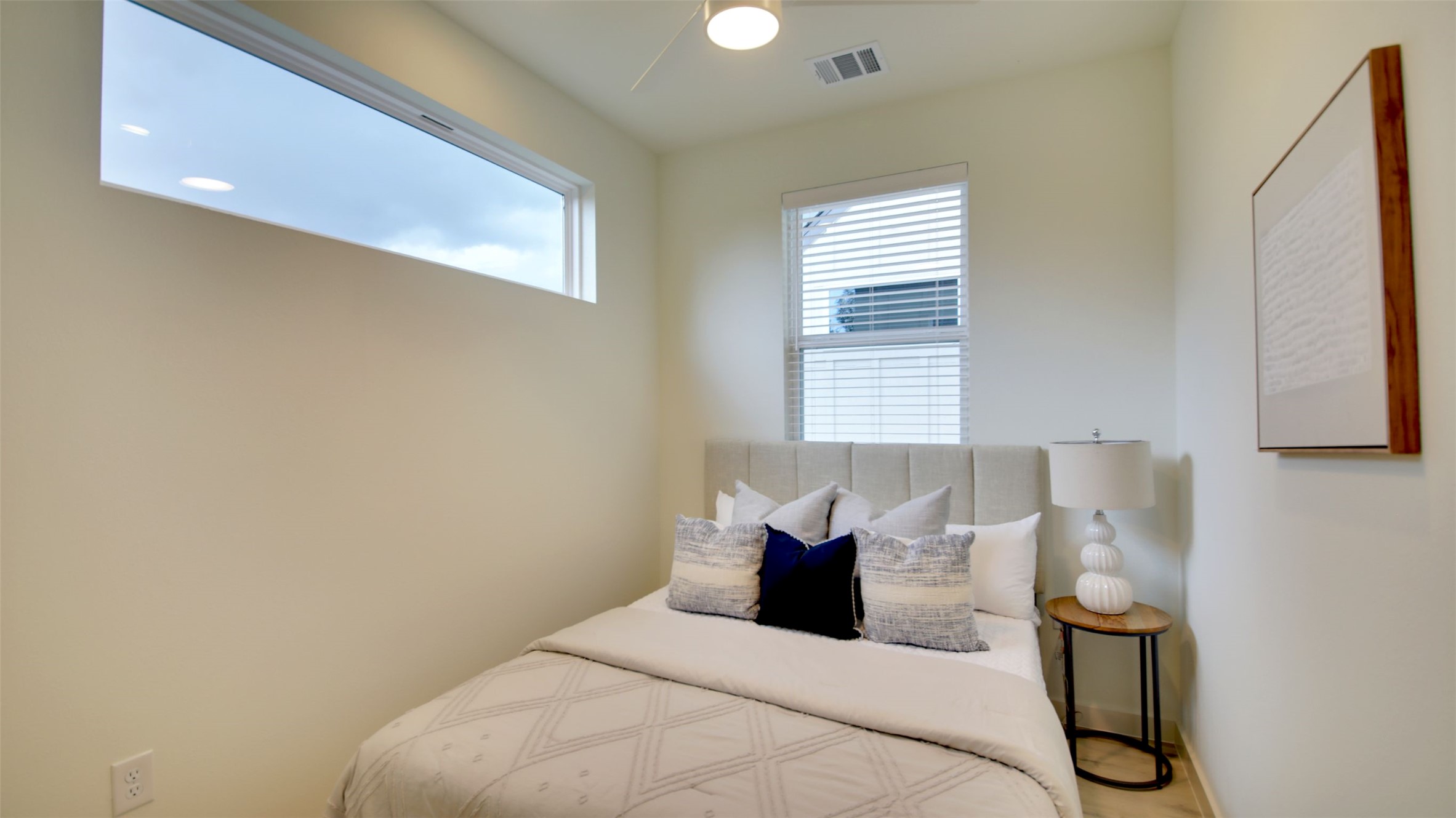 6802 Montana Street, Unit 2 Austin, TX 78741 - Photo 9 of 13 This cozy chamber features a sleek ceiling fan and ample natural light through well-placed windows.