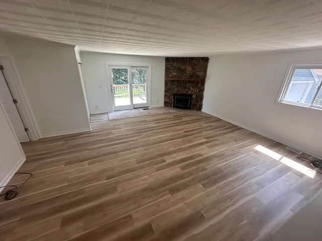wooden floor in an empty room with a window