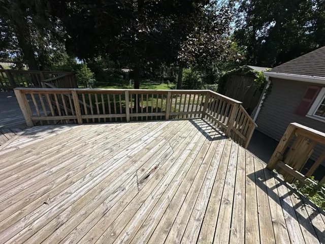 a view of balcony with wooden floor and fence