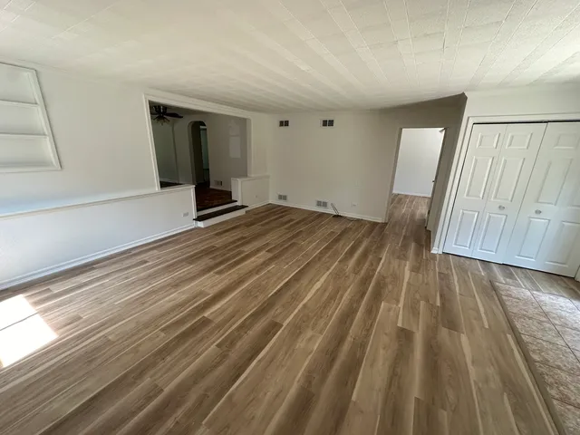 a view of a room with wooden floor and stairs