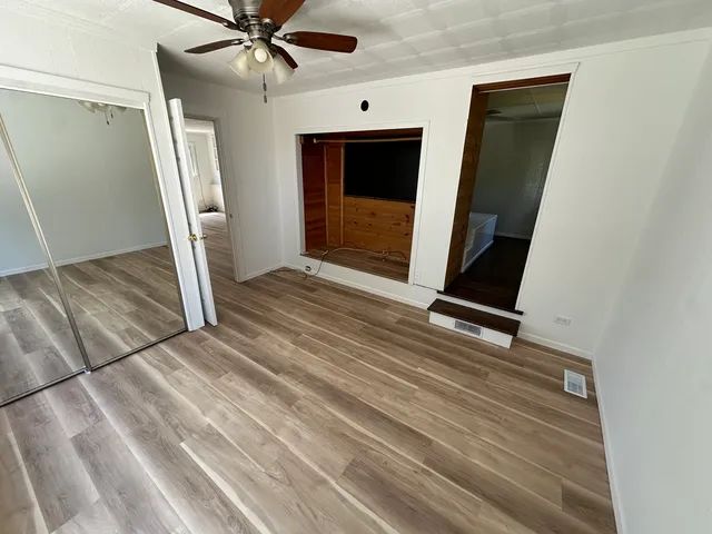 en empty room with wooden floor and window