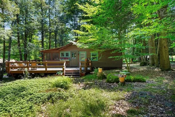a backyard of a house with lots of green space and fountain