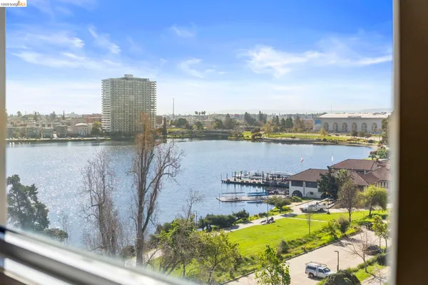 a living room with furniture floor to ceiling window and wooden floor