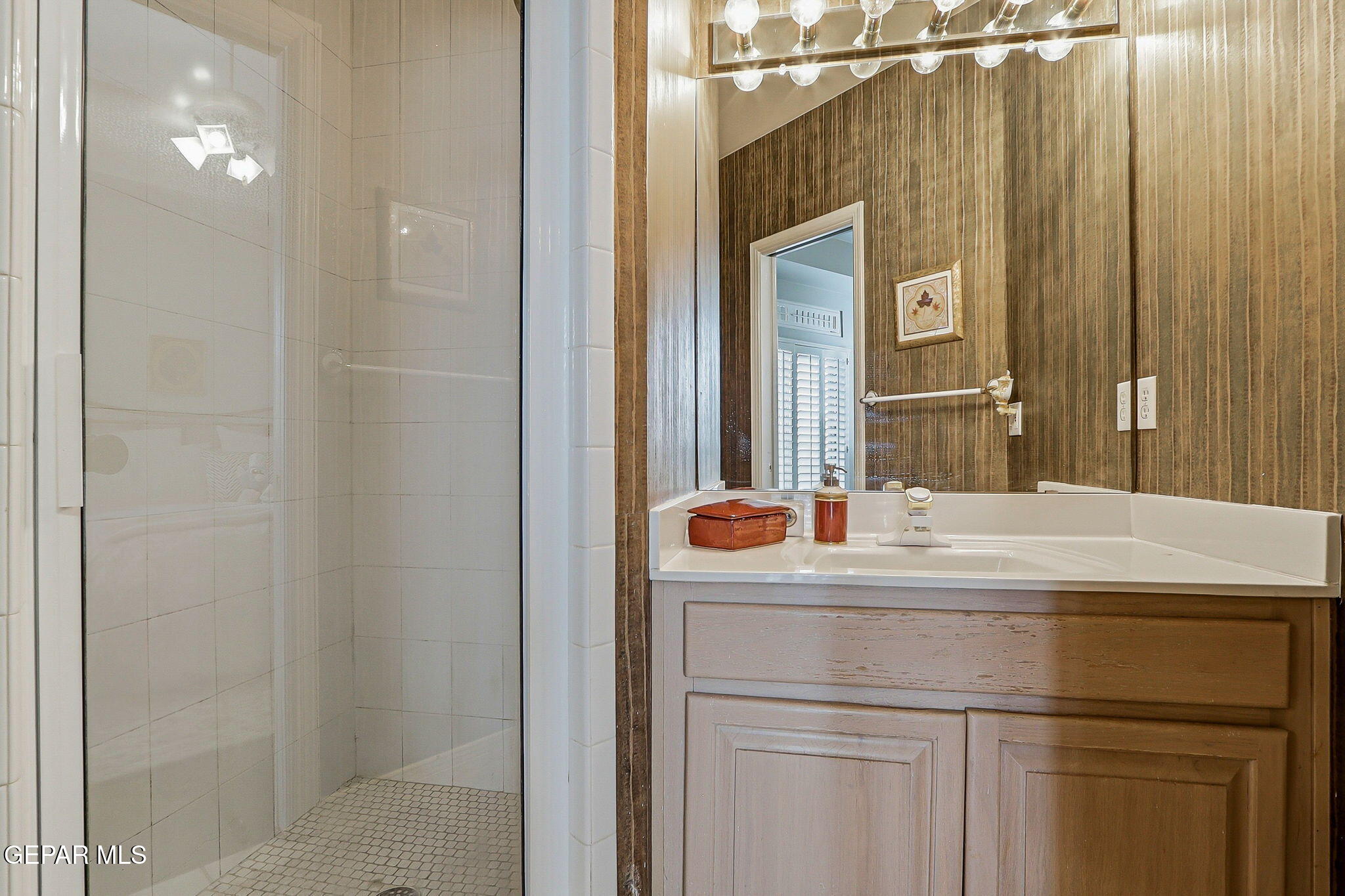 5806 Diamond Point Circle El Paso, TX 79912 - Photo 43 of 61 a bathroom with a sink and mirror