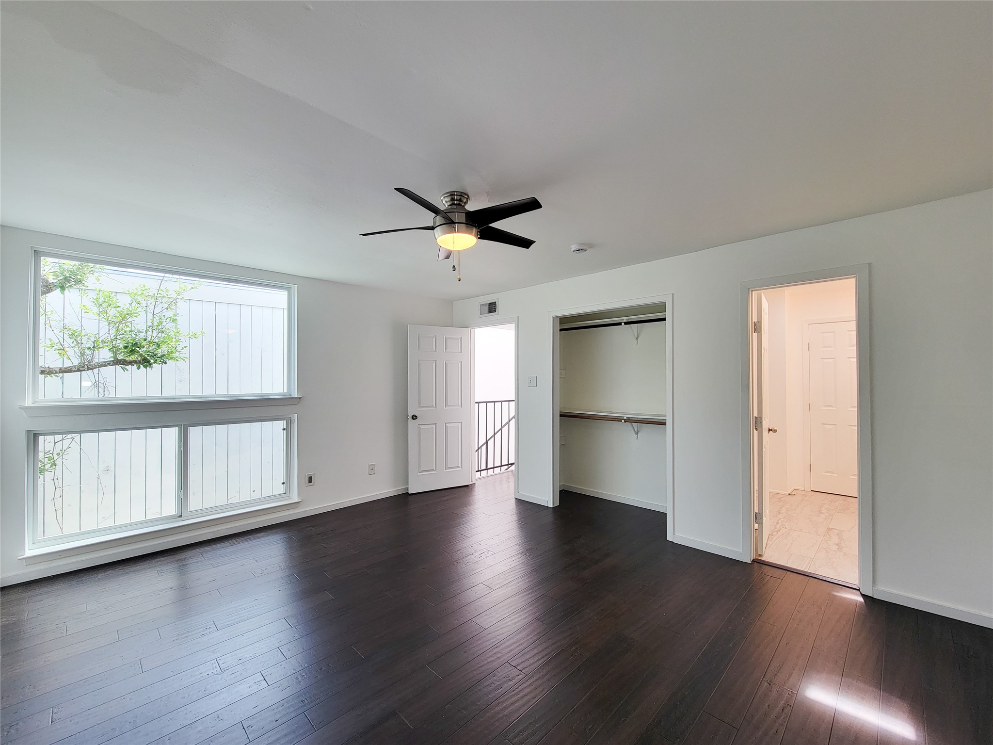 2243 West Alabama Street, Unit B Houston, TX 77098 - Photo 24 of 44 a view of an empty room with a window and wooden floor