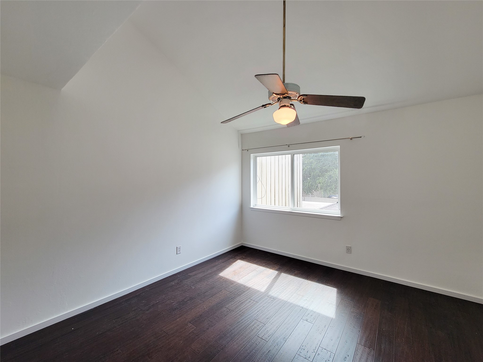 2243 West Alabama Street, Unit B Houston, TX 77098 - Photo 29 of 44 a view of an empty room with wooden floor and a window