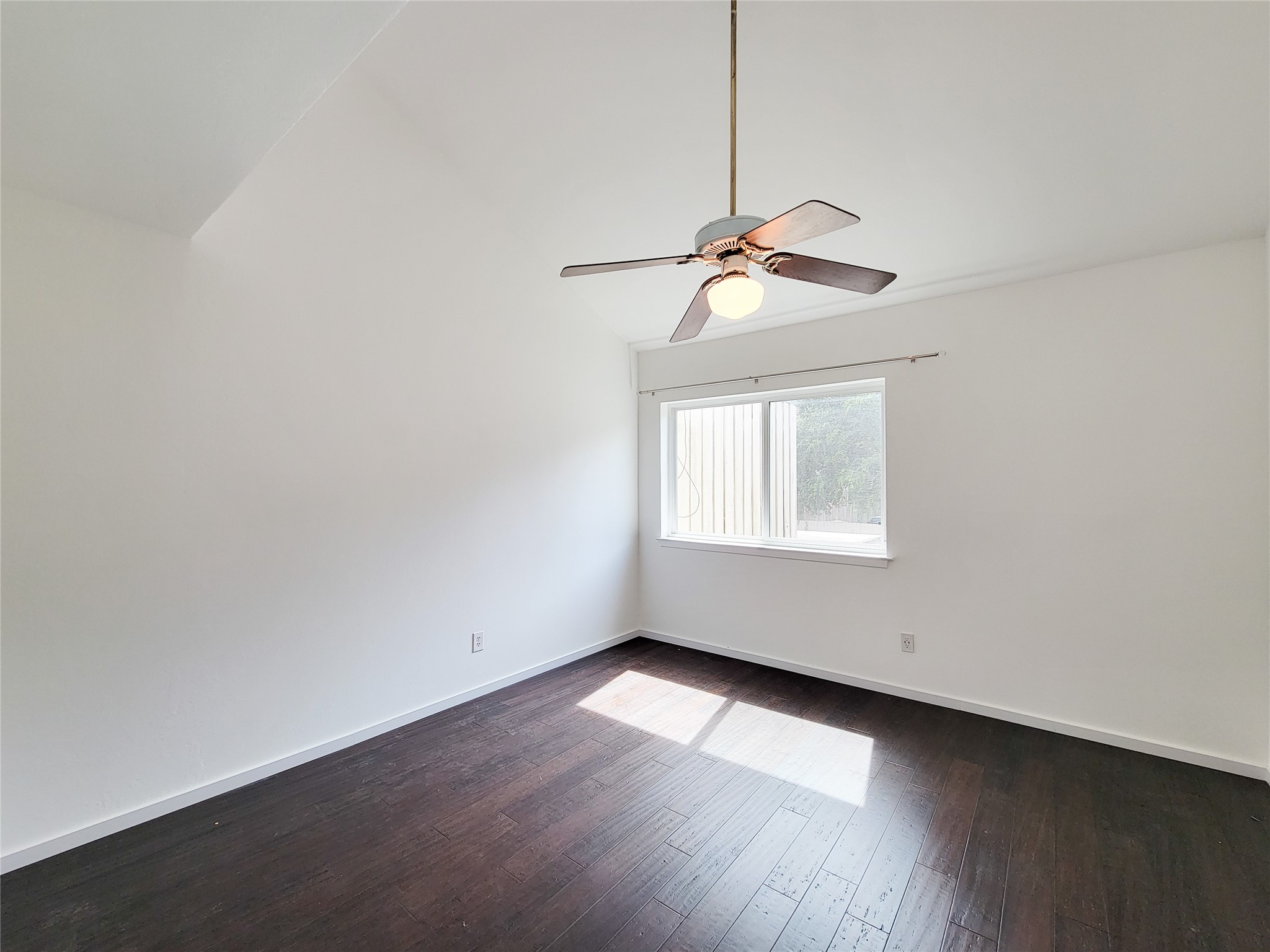 2243 West Alabama Street, Unit B Houston, TX 77098 - Photo 31 of 44 a view of an empty room with wooden floor and a window