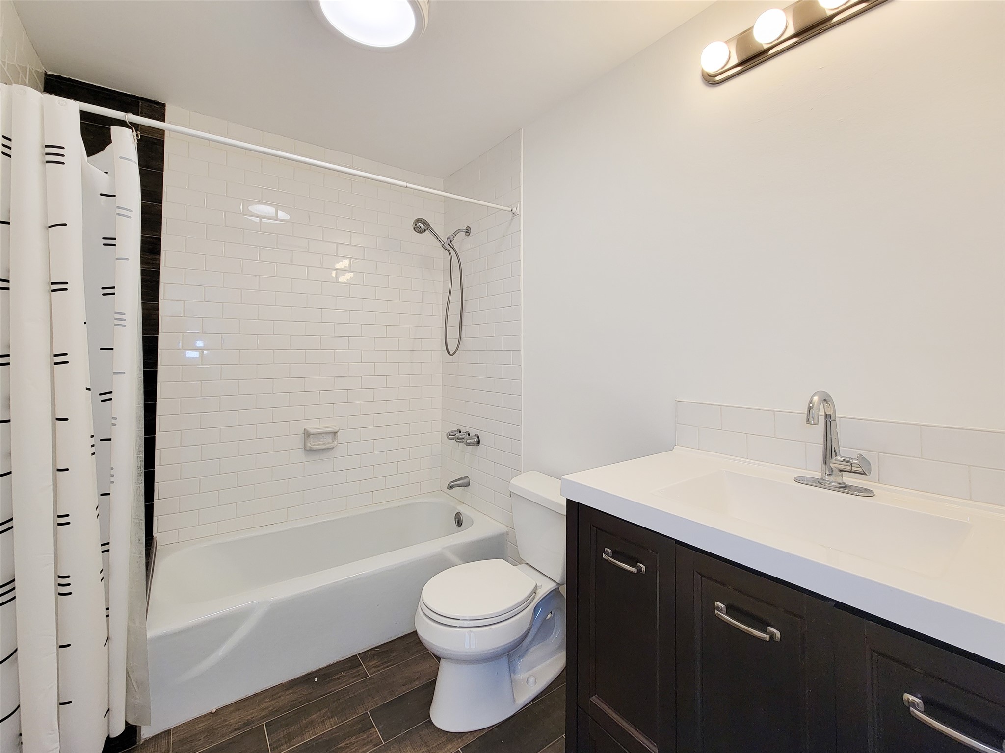 2243 West Alabama Street, Unit B Houston, TX 77098 - Photo 32 of 44 a bathroom with a sink a toilet and shower