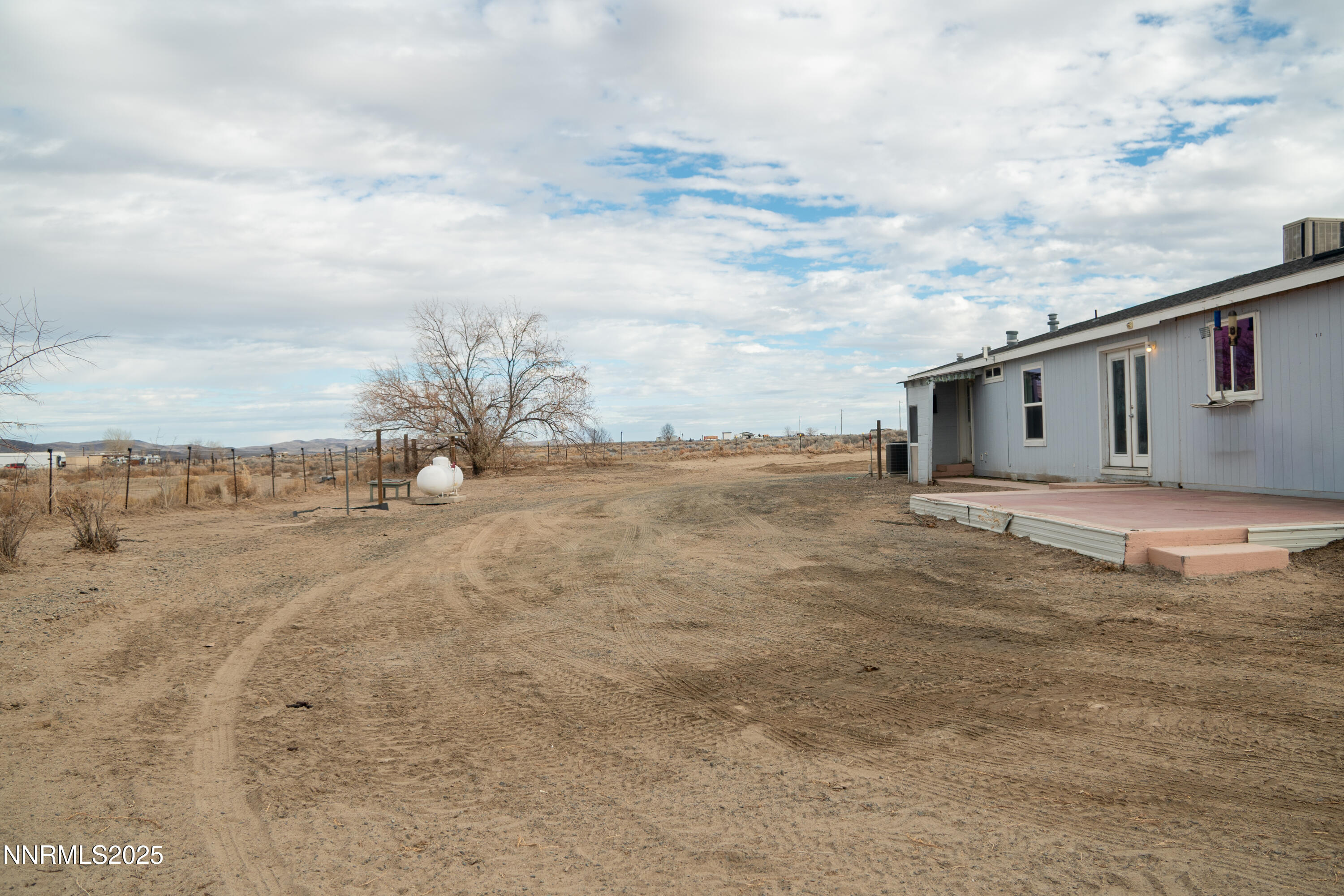 3250 4th Street Silver Springs, NV 89429 - Photo 21 of 73 a view of a dry yard with wooden fence