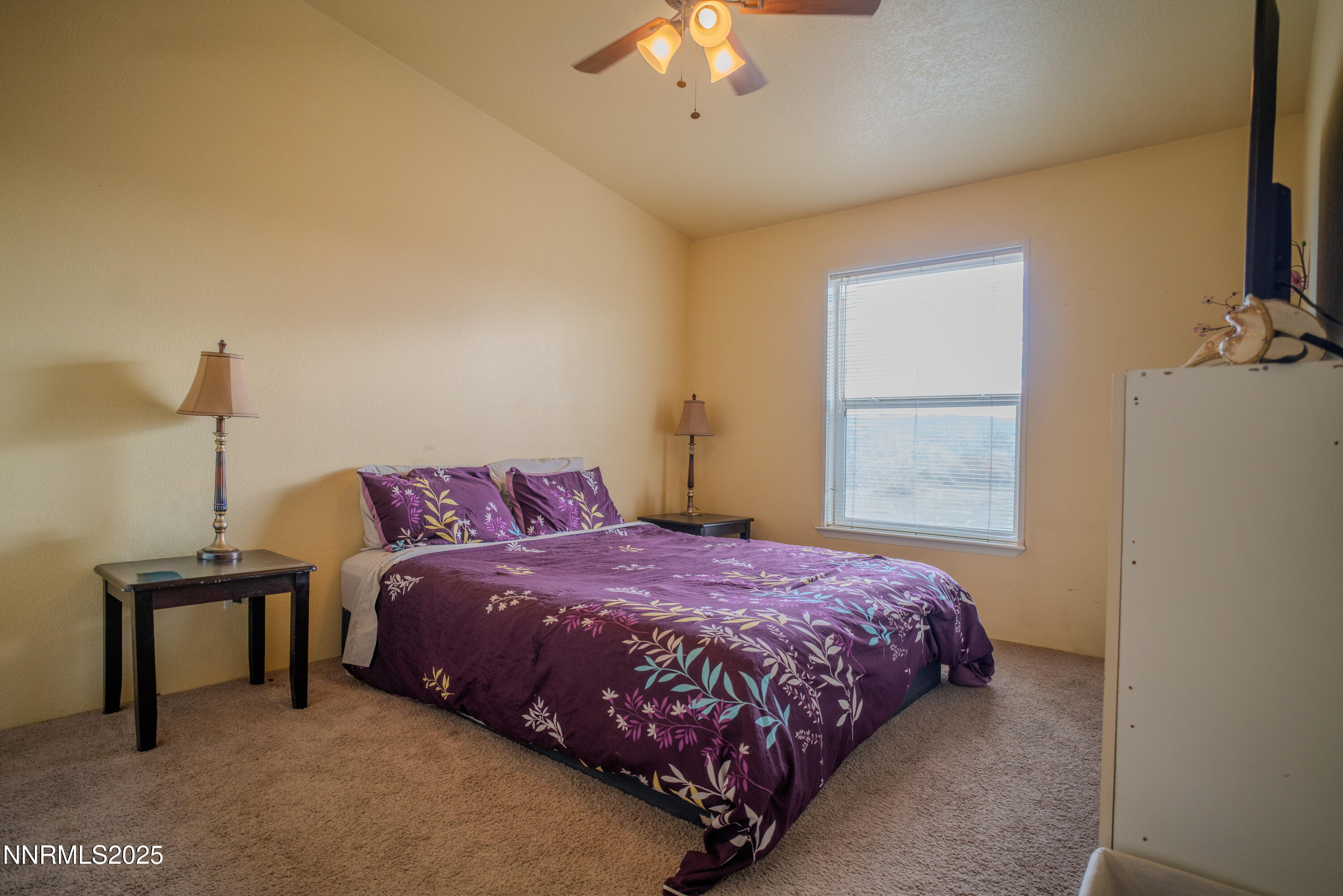 3250 4th Street Silver Springs, NV 89429 - Photo 26 of 73 a bedroom with a bed and a chandelier