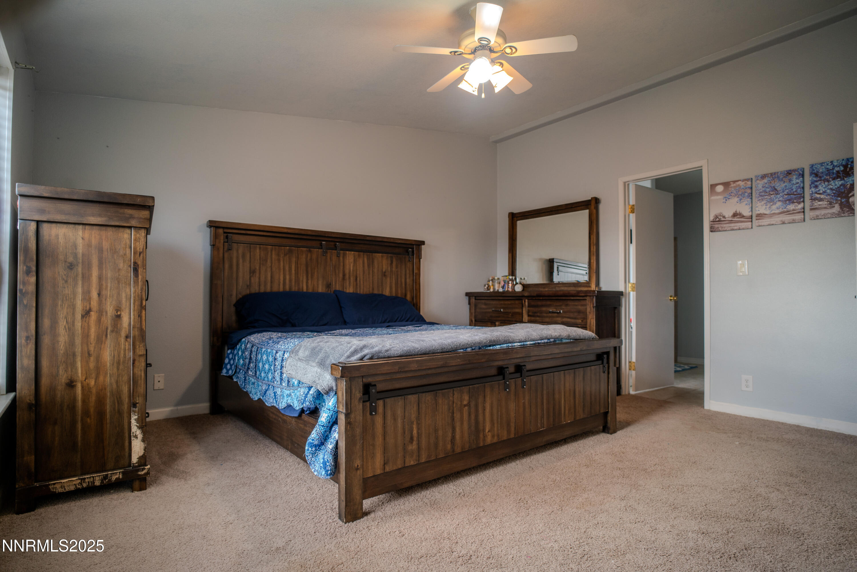 3250 4th Street Silver Springs, NV 89429 - Photo 33 of 73 a bedroom with a bed and a chandelier