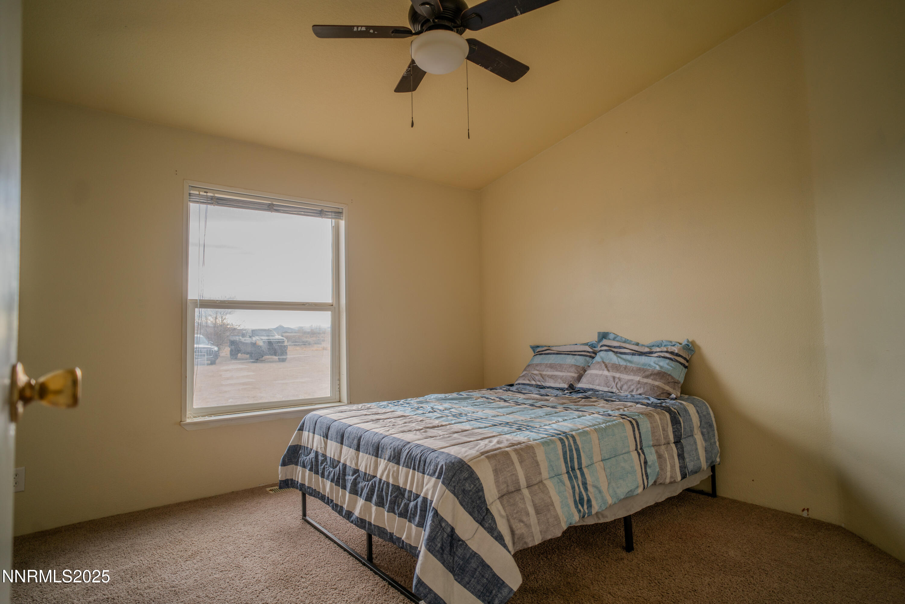 3250 4th Street Silver Springs, NV 89429 - Photo 37 of 73 a bedroom with a bed and a window