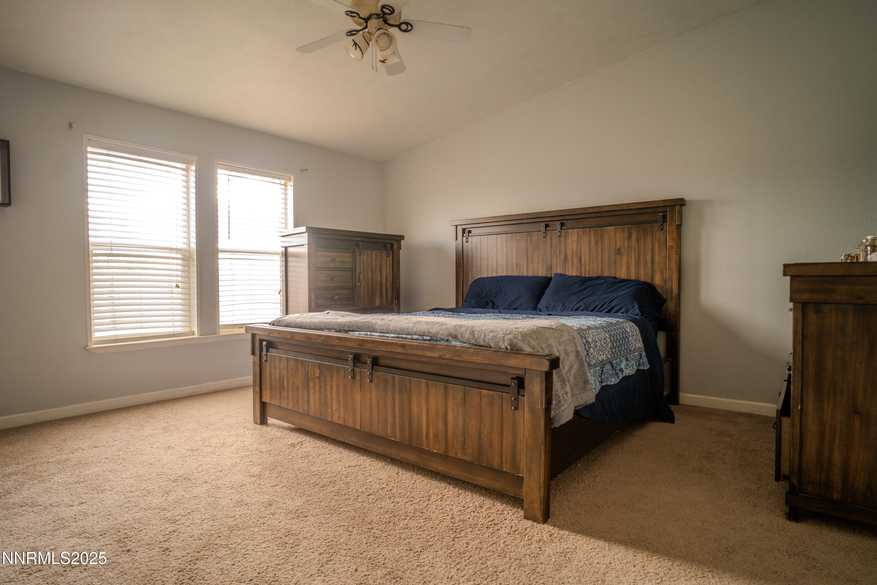 3250 4th Street Silver Springs, NV 89429 - Photo 41 of 73 a bedroom with a bed and a chandelier