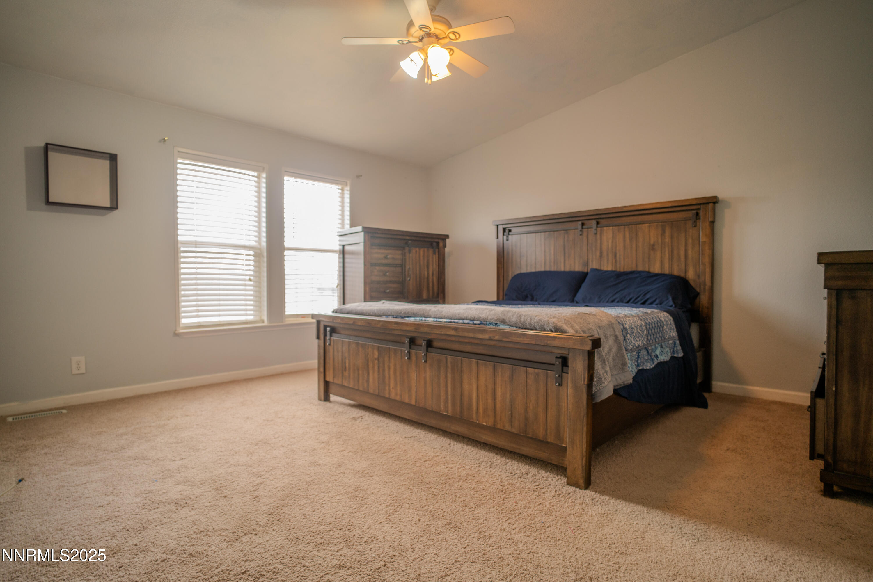 3250 4th Street Silver Springs, NV 89429 - Photo 42 of 73 a bedroom with a bed and a chandelier