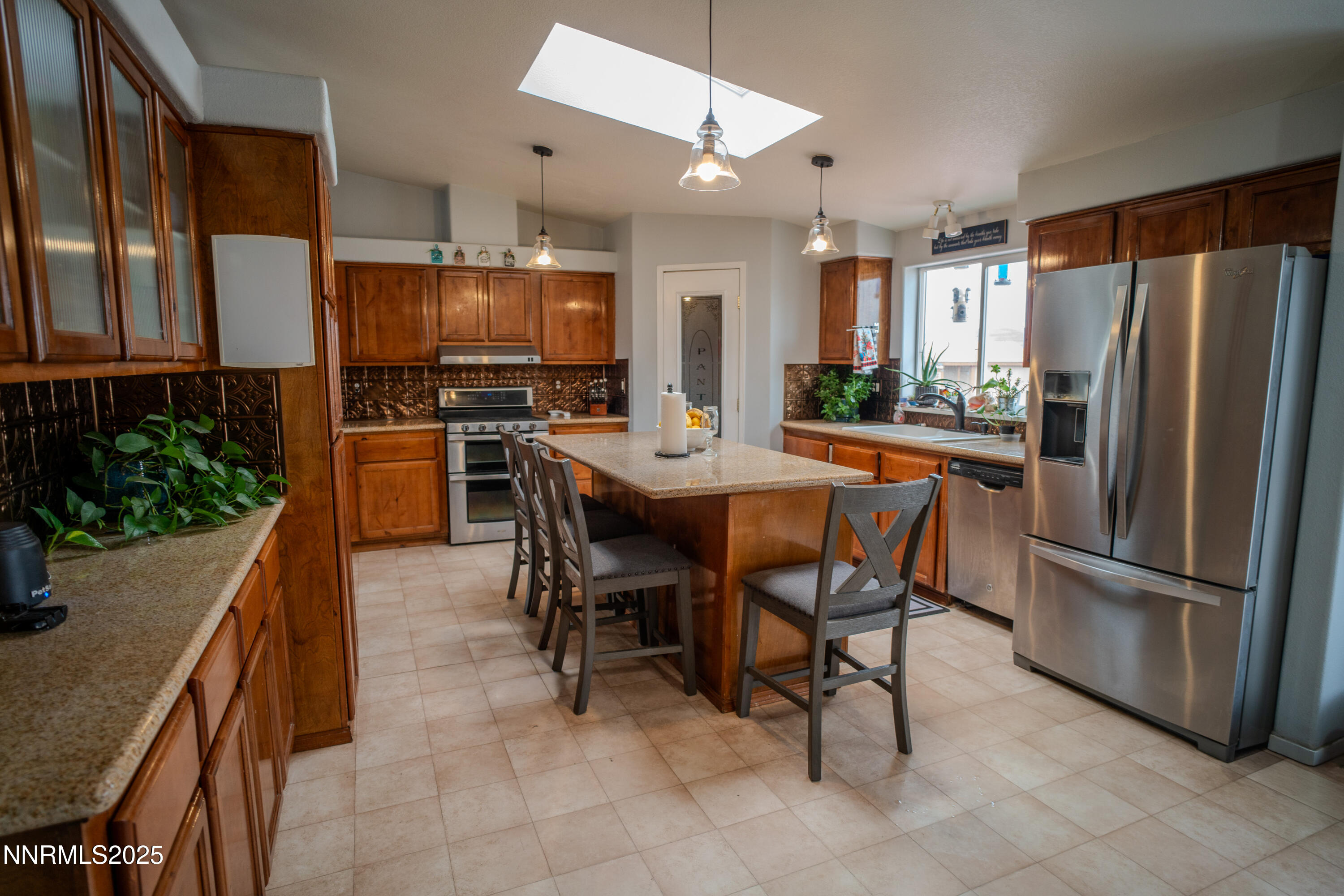 3250 4th Street Silver Springs, NV 89429 - Photo 44 of 73 a dining hall with stainless steel appliances granite countertop a table chairs and a refrigerator