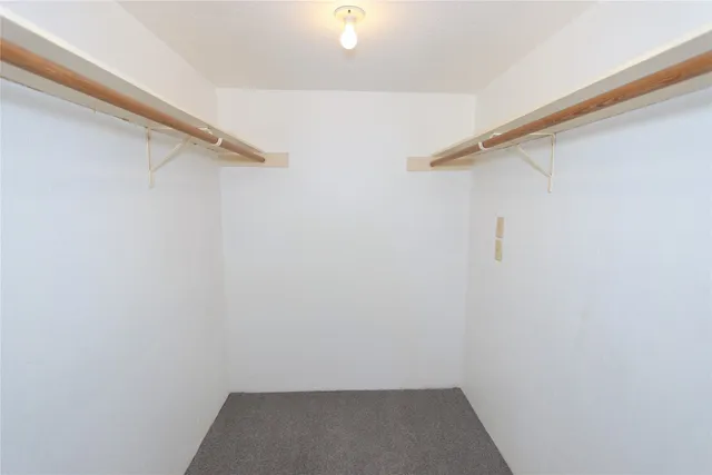 a bathroom with a bathtub shower sink vanity mirror and toilet