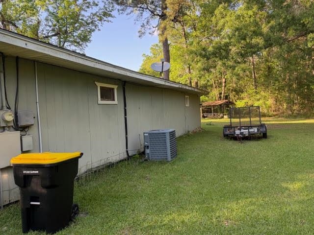 235 Connell Road Vidor, TX 77662 - Photo 5 of 35 a view of a back yard of the house with a car parked