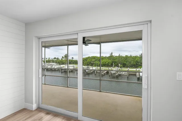 a room with a large window and wooden floor