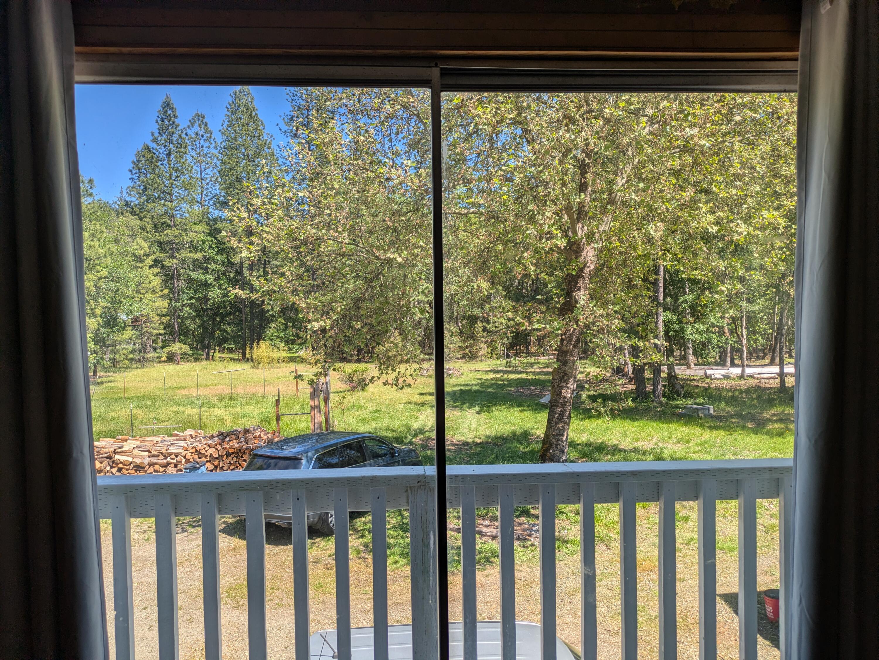 575 Kirkham Road Cave Junction, OR 97523 - Photo 42 of 45 a view of a porch and a yard