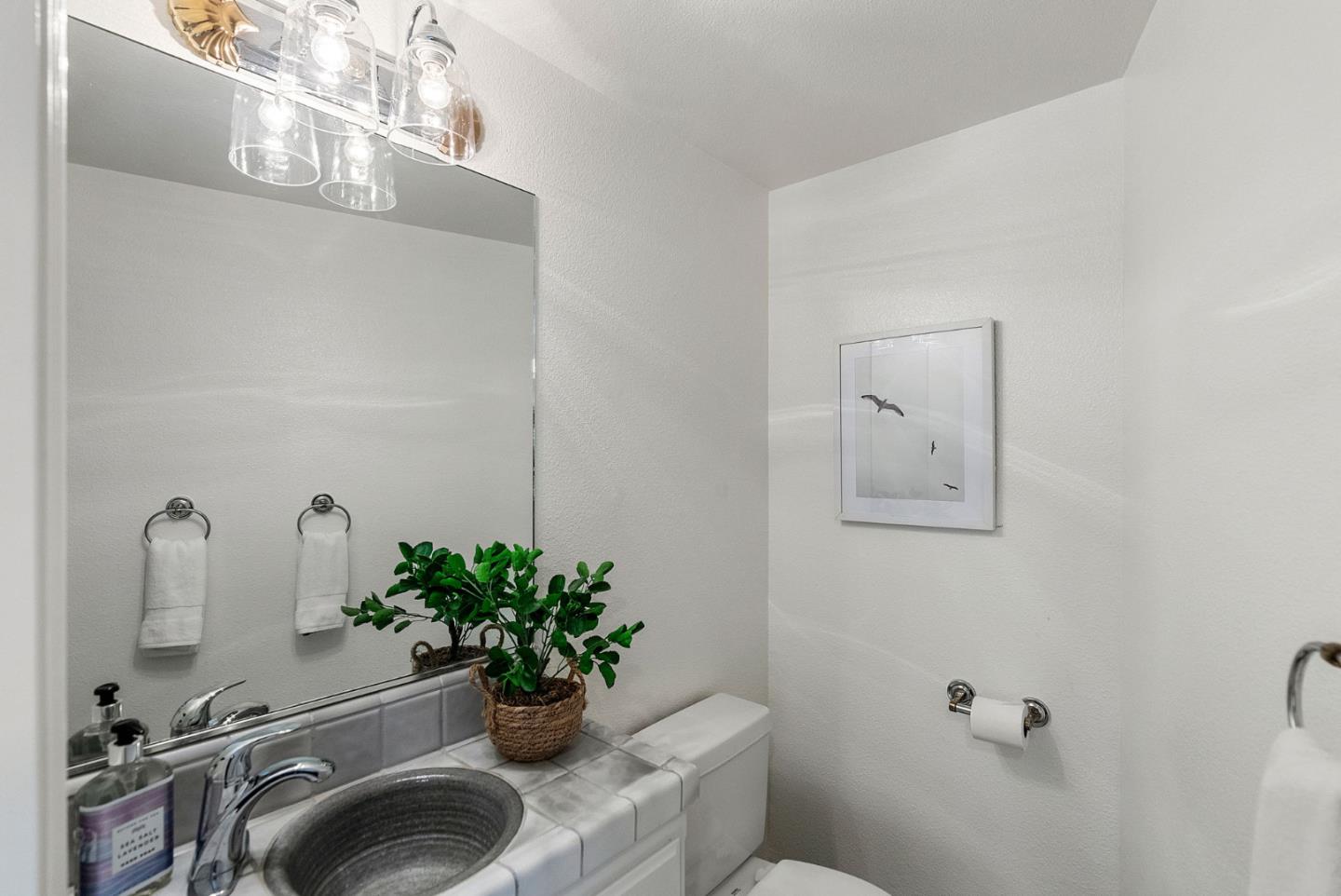 1817 Via Pacifica Aptos, CA 95003 - Photo 19 of 40 a bathroom with a sink a toilet and mirror