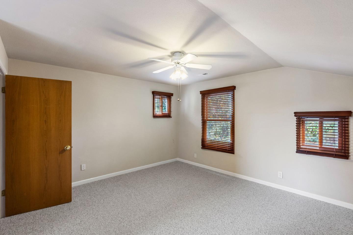 1817 Via Pacifica Aptos, CA 95003 - Photo 22 of 40 an empty room with windows and ceiling fan