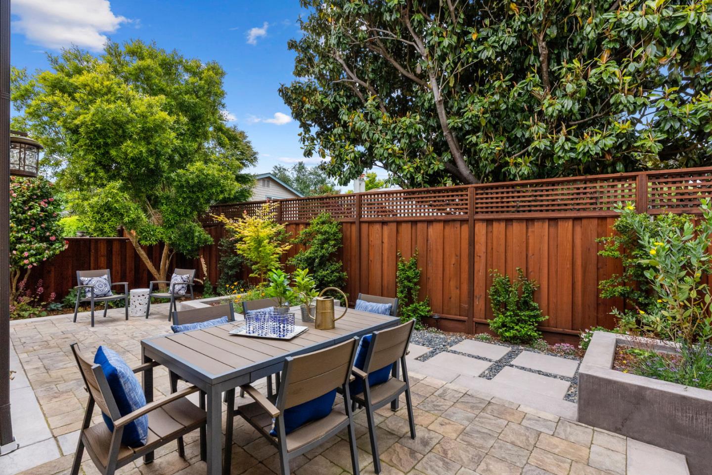 1817 Via Pacifica Aptos, CA 95003 - Photo 25 of 40 a backyard of a house with dining table and chairs with plants
