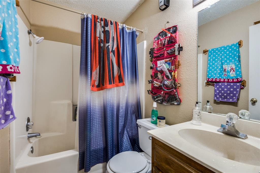 3309 Fallmeadow Street Denton, TX 76207 - Photo 11 of 12 a bathroom with a sink toilet and shower