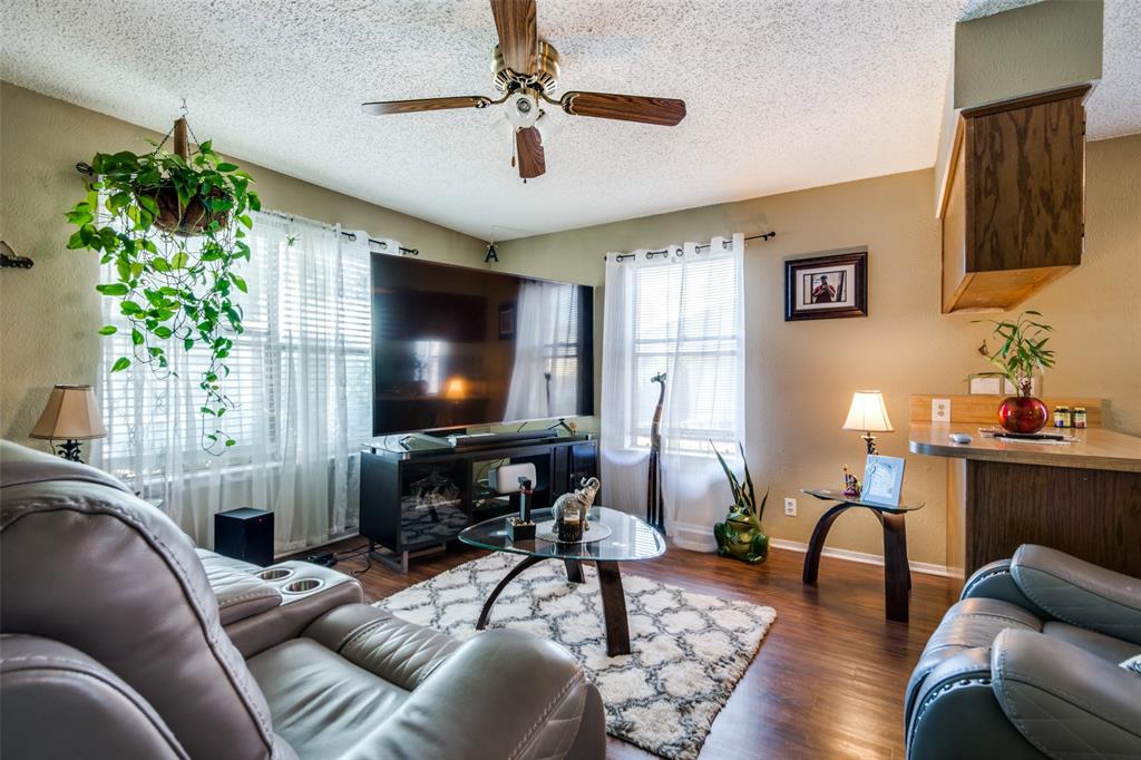 3309 Fallmeadow Street Denton, TX 76207 - Photo 3 of 12 a living room with furniture and a flat screen tv