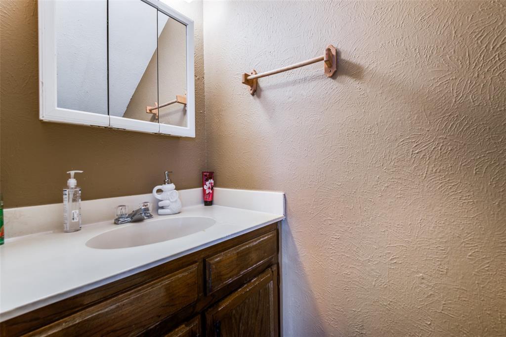 3309 Fallmeadow Street Denton, TX 76207 - Photo 8 of 12 a bathroom with a sink and a mirror