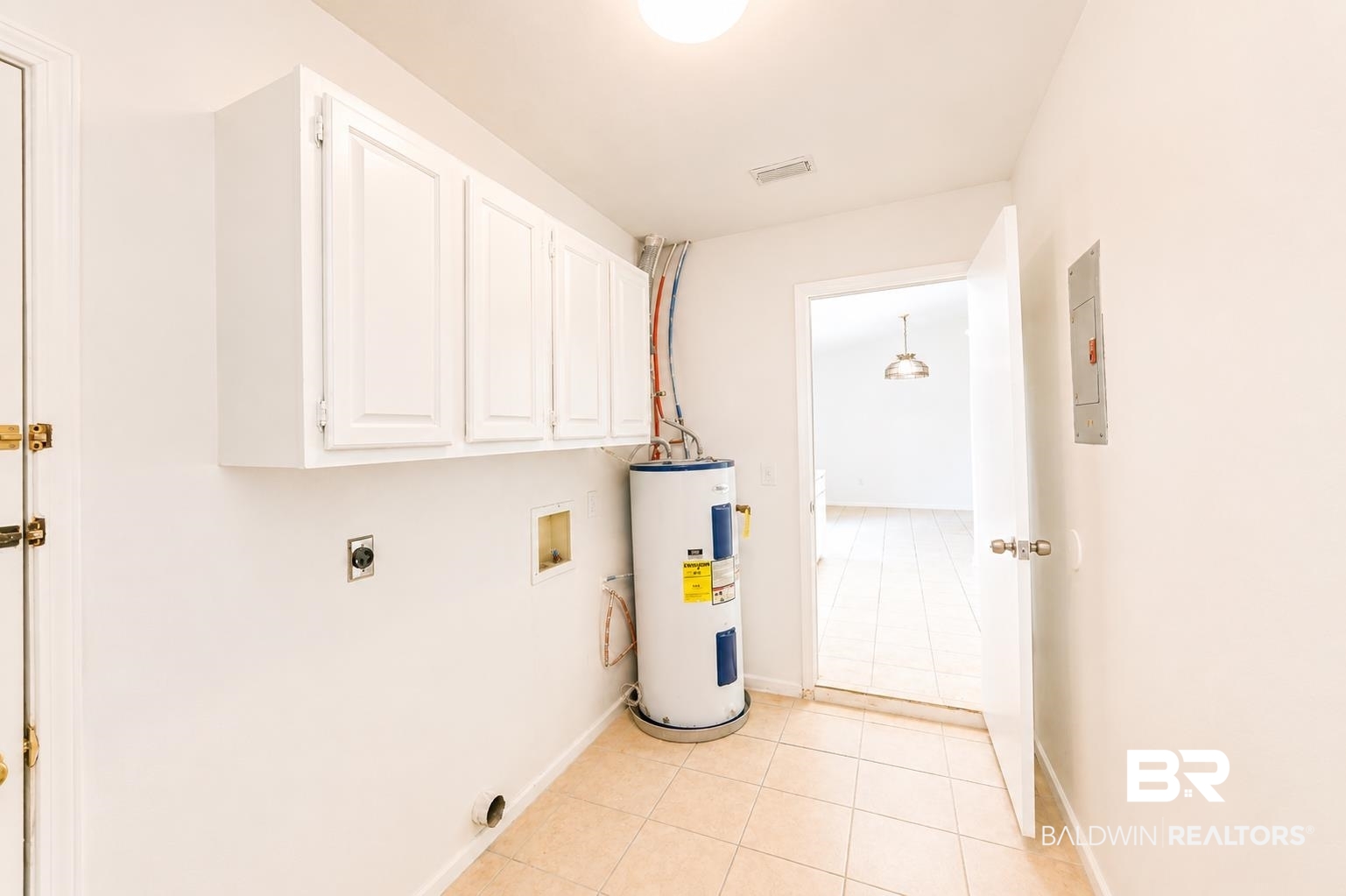 614 East Gate Circle Foley, AL 36535 - Photo 14 of 31 Utility room featuring white shaker-style cabinetry, a water heater, and light-toned tile flooring
