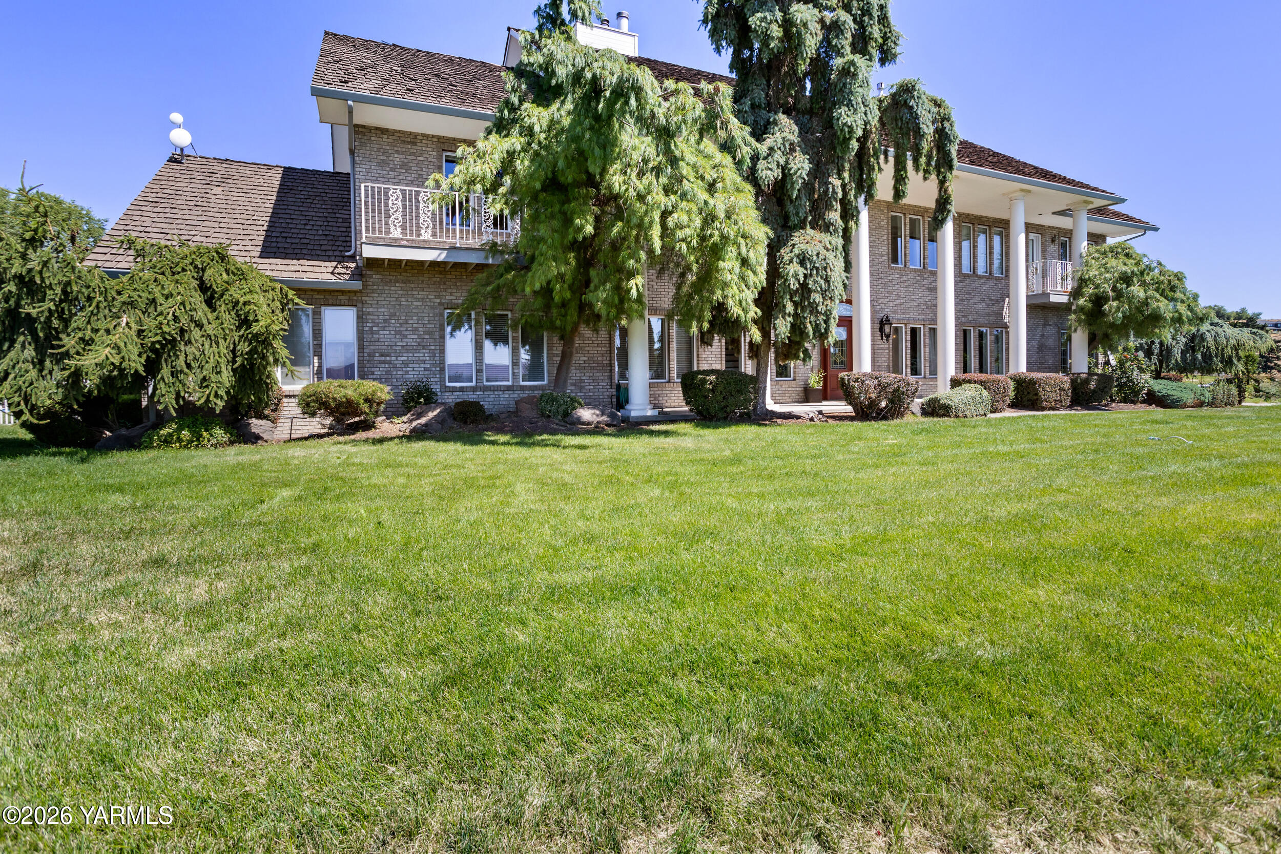 14801 Summitview Ext Road Yakima, WA 98908 - Photo 4 of 80 a view of a building with a yard and large trees