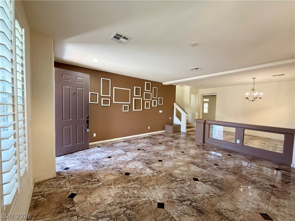 6459 Parrot Ridge Court Las Vegas, NV 89139 - Photo 4 of 23 Enter into a spacious living area featuring exquisite tile flooring and abundant natural light.