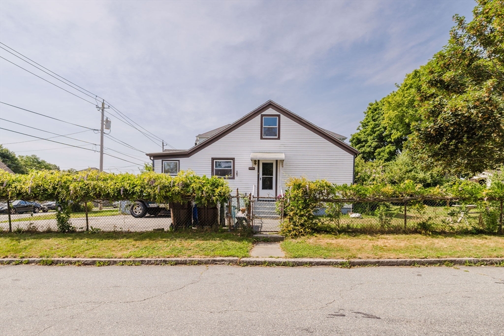 1957 Rodman Street Fall River, MA 02721 - Photo 13 of 32 a front view of a house with a yard