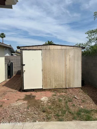 a view of a garage with wooden fence
