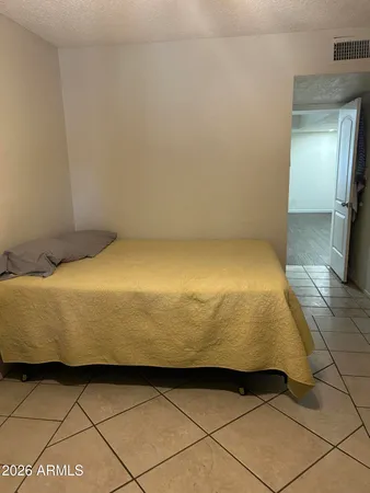 a bed sitting in a room next to a window