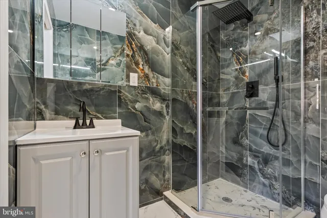 a bathroom with a shower and sink