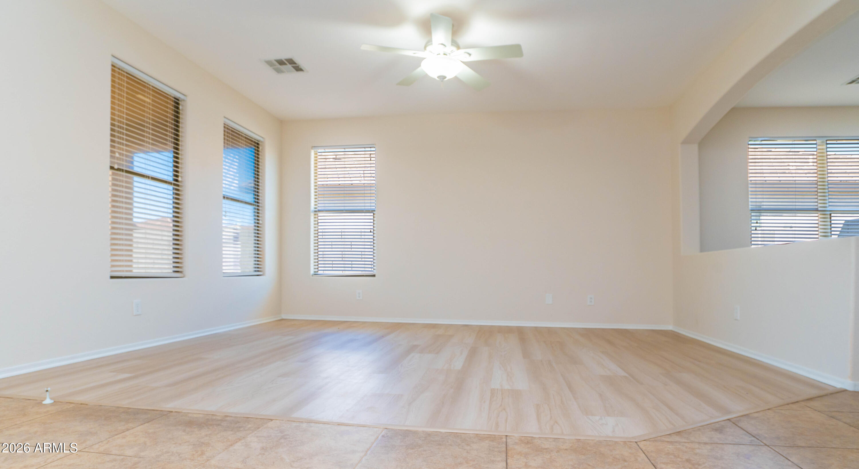 45633 West Mountain View Road Maricopa, AZ 85139 - Photo 12 of 78 wooden floor in an empty room with a window
