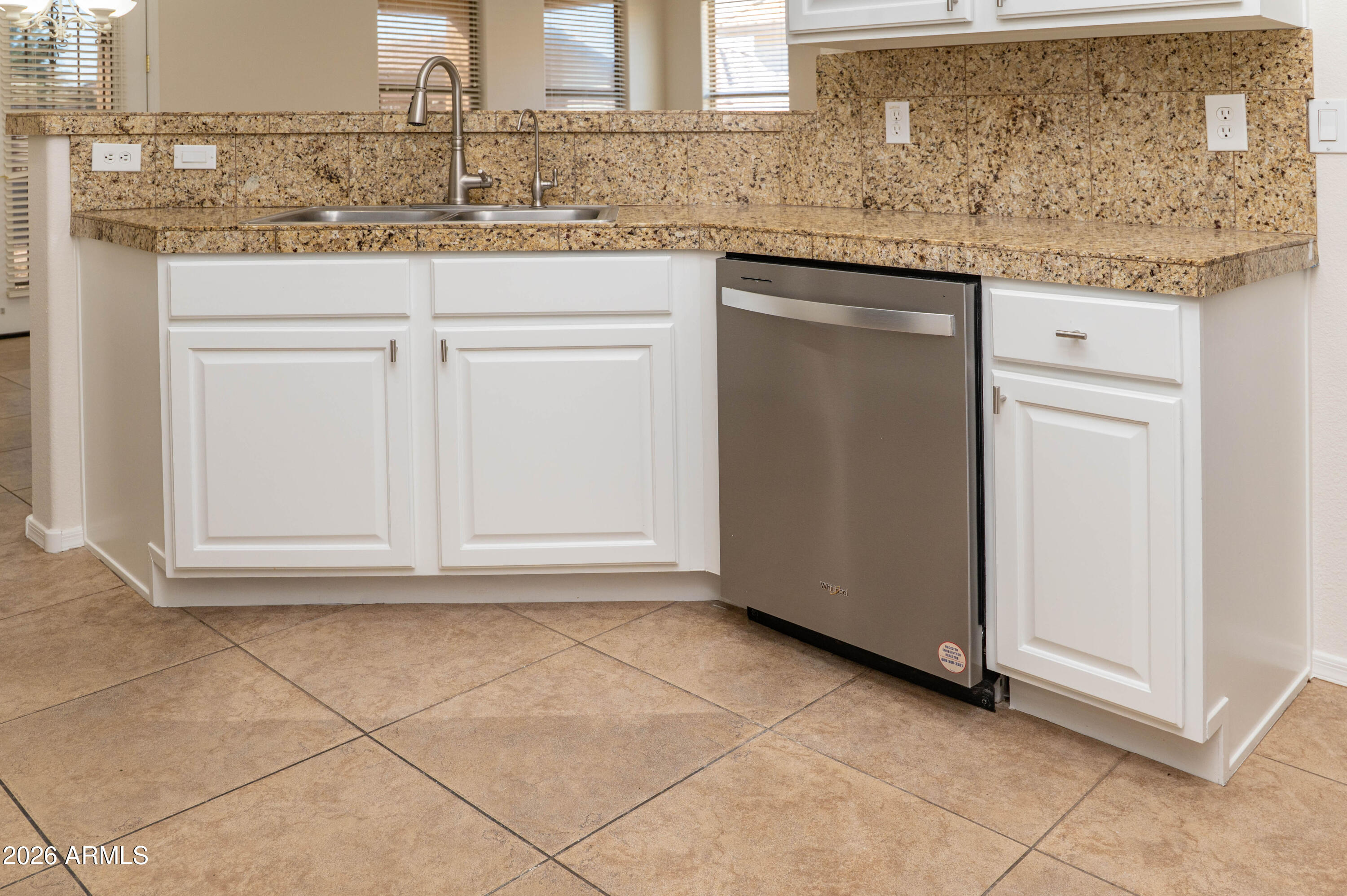 45633 West Mountain View Road Maricopa, AZ 85139 - Photo 19 of 78 a kitchen with granite countertop a sink and a white cabinets